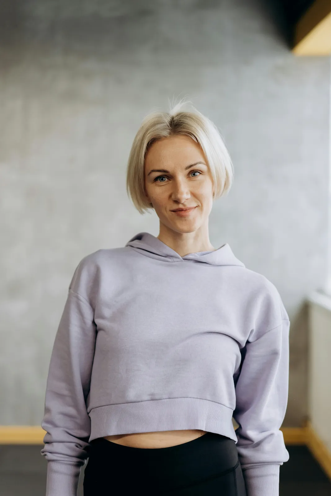 A woman in a lilac hooded sweatshirt